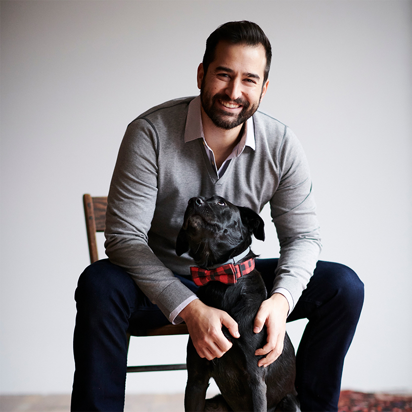 Nathan Mirizio sits with his dog. 